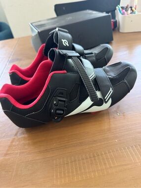 Peloton black and red cycling shoes with white accents